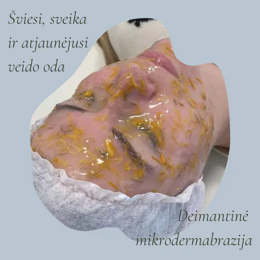 Klientės veidas su raminančia gelio kauke, kurioje matyti medetkų žiedlapiai